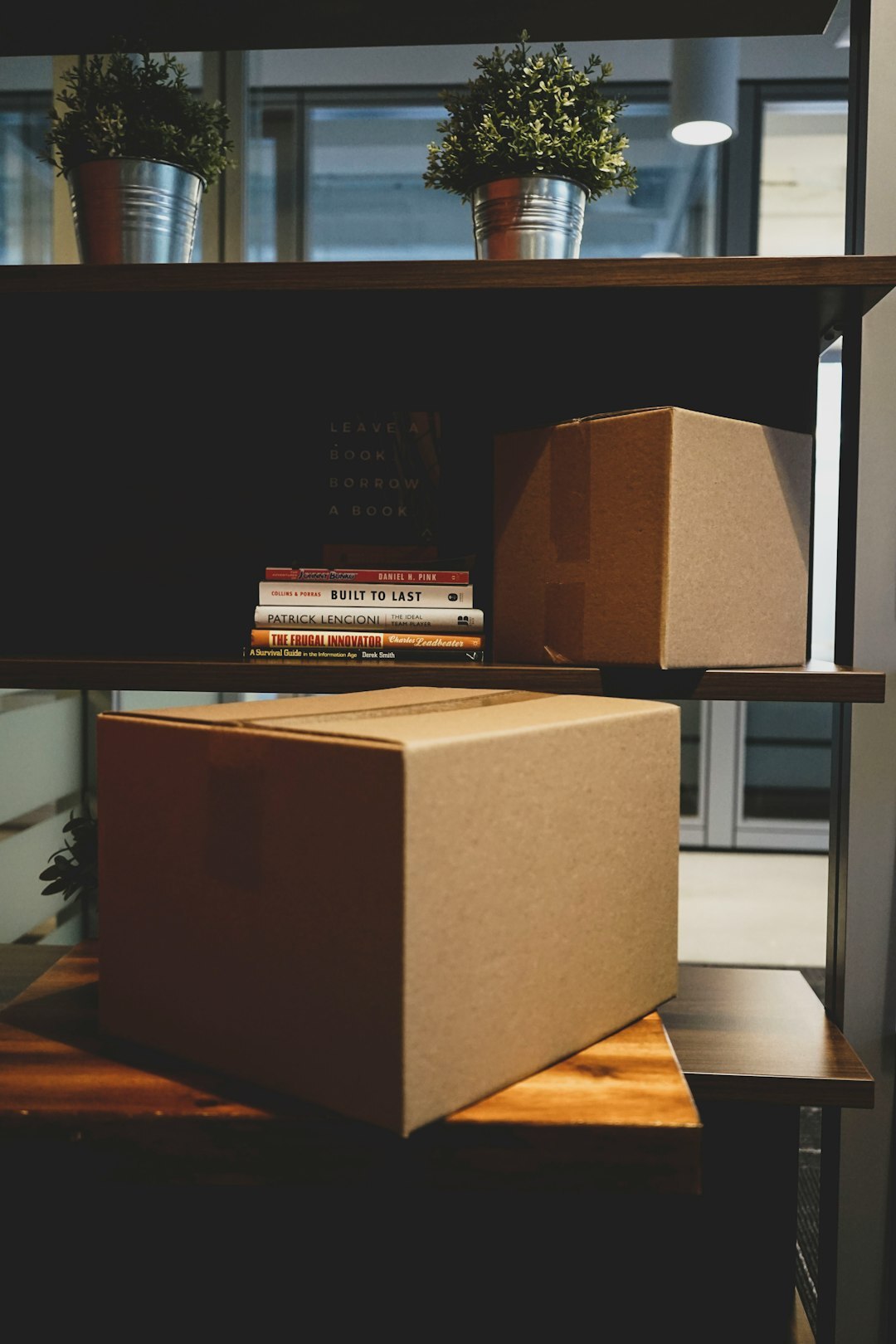 Open cardboard delivery boxes on a desk next to a laptop
