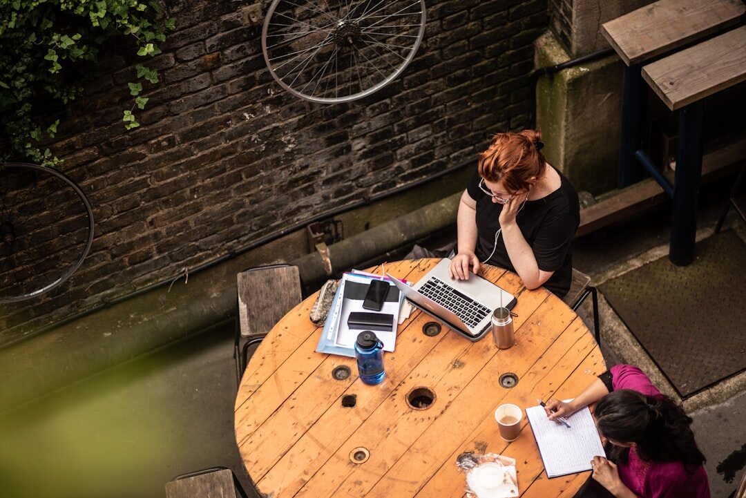Overhead view of a team working with documents and a laptop on a table