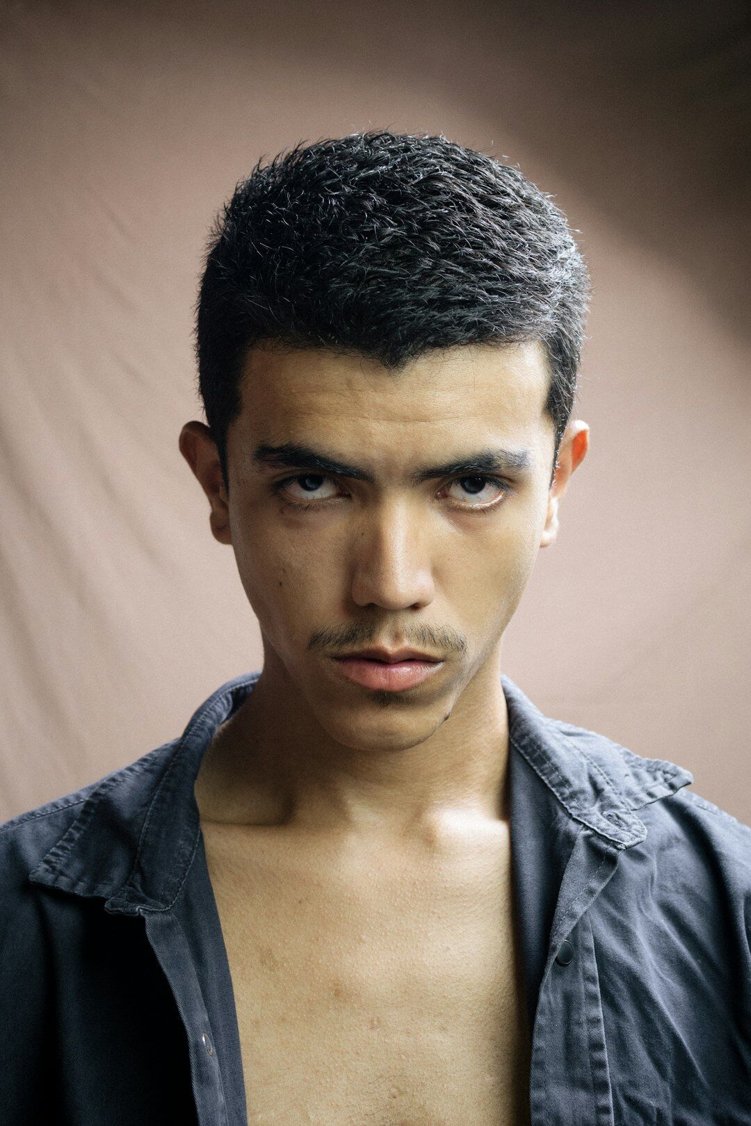 Studio portrait of a young man with short black hair