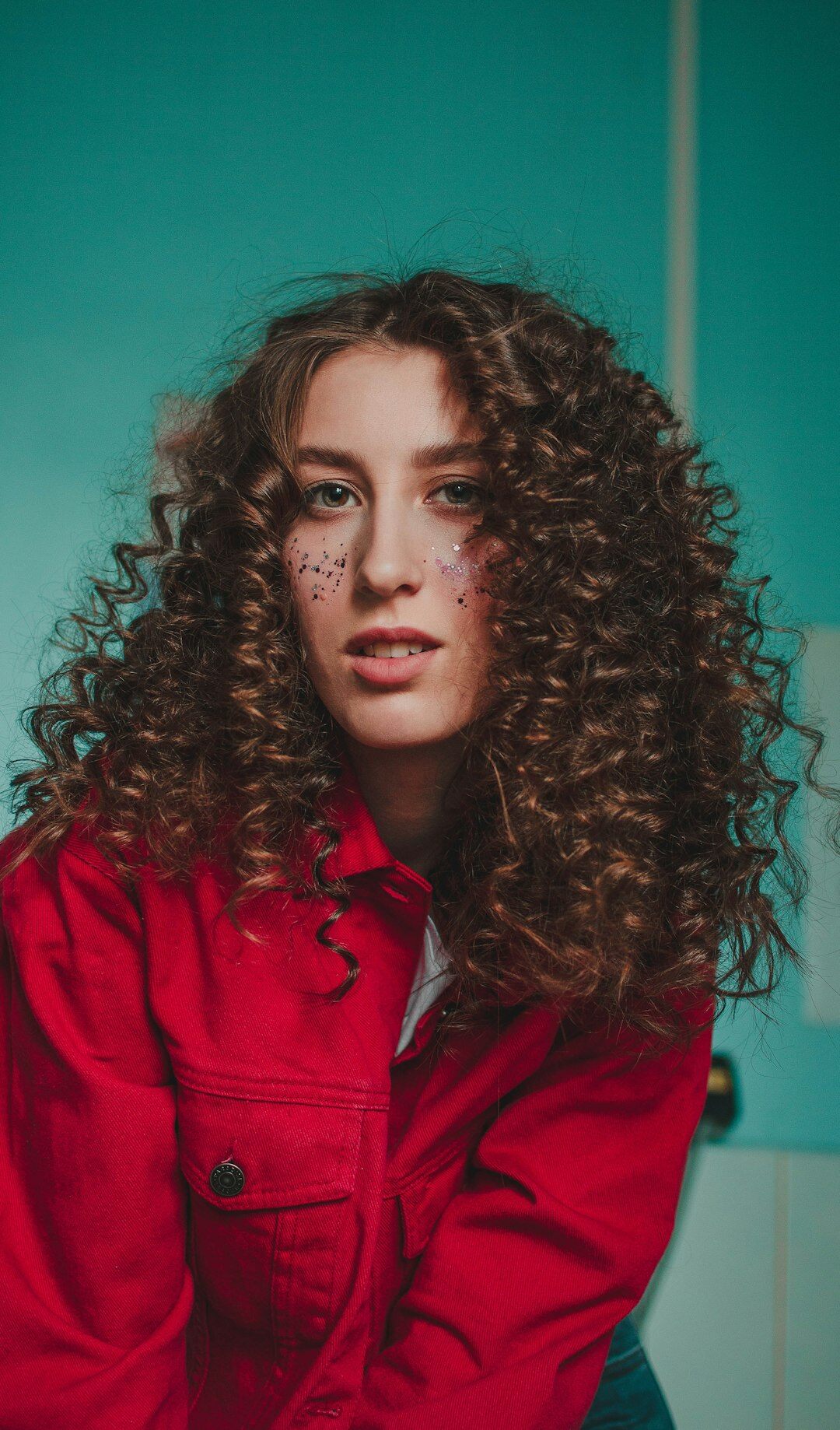 Studio portrait of a young woman with curly hair