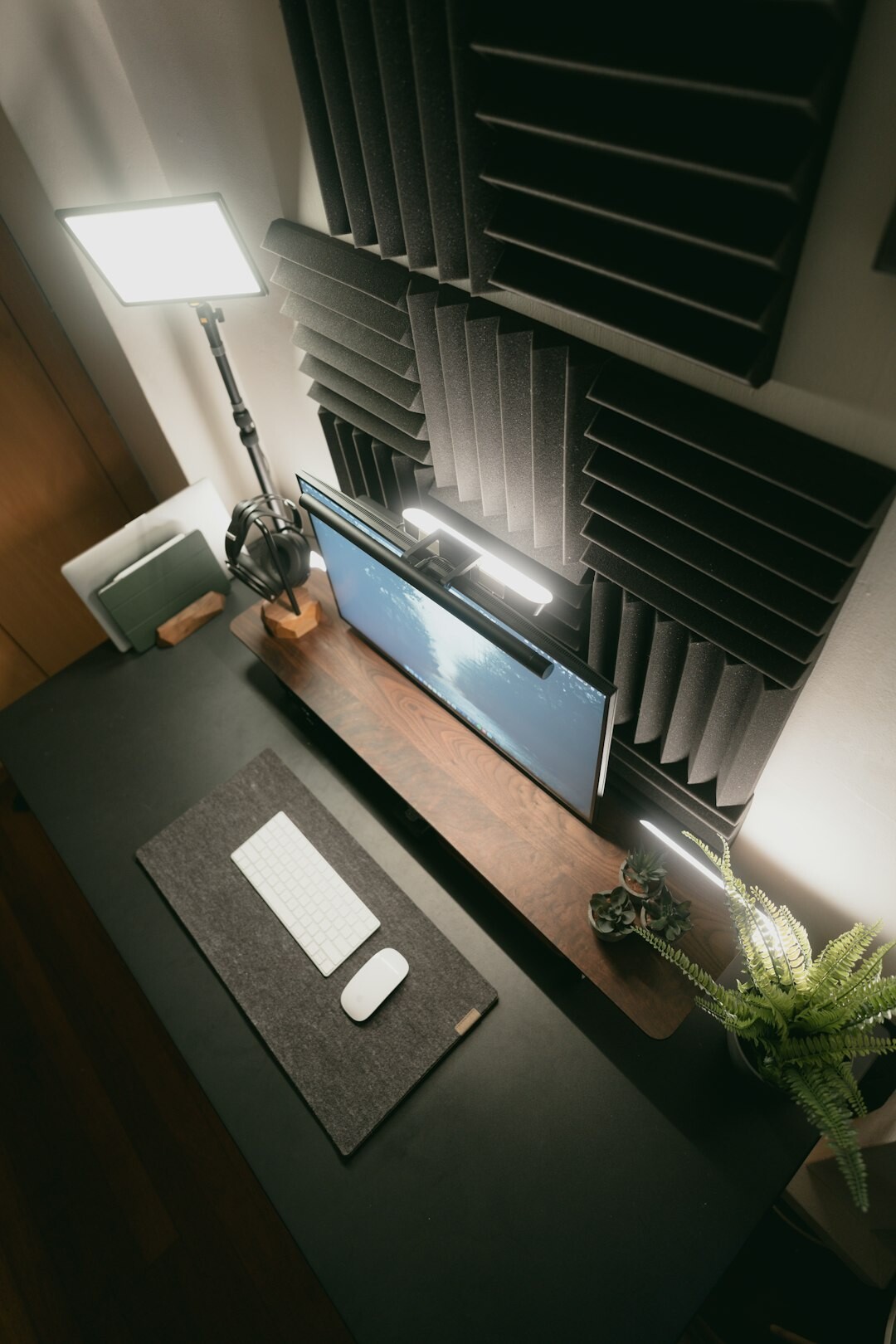 Workspace with notebooks, a laptop and printed charts on a wooden desk